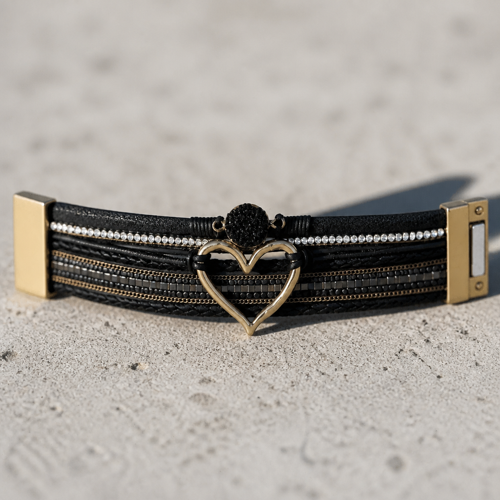 Black layered leather bracelet featuring an open gold heart, crystal accents, rhinestone details, and magnetic clasp.