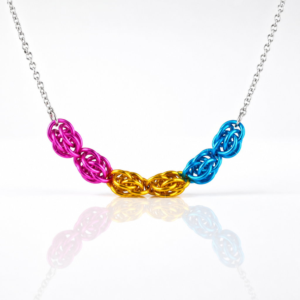 Hand-linked pansexual pride chainmail necklace featuring pink, yellow, and blue aluminum rings on an adjustable stainless steel chain on a white background