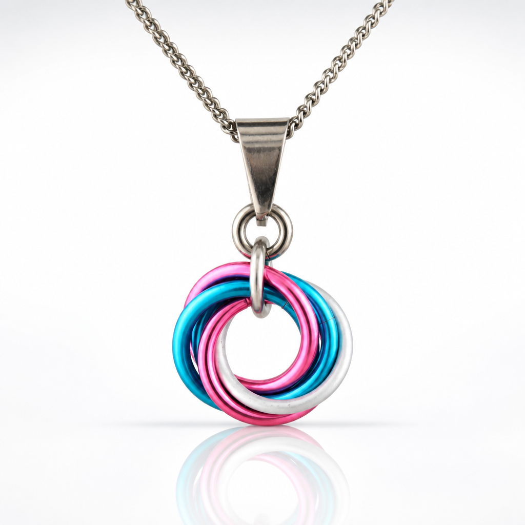 Handcrafted Transgender Pride swirl pendant necklace featuring blue, pink, and white aluminum rings on an adjustable stainless steel chain.