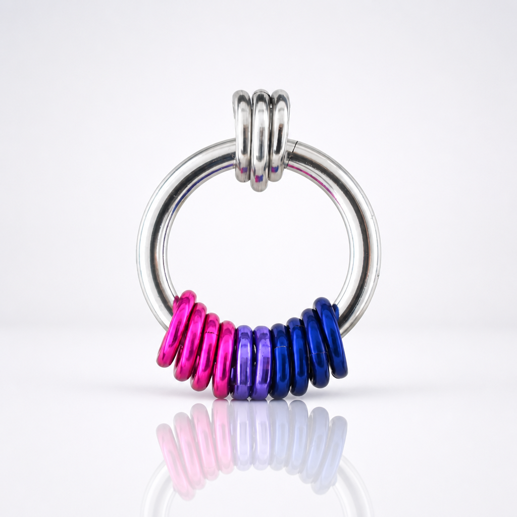 Handcrafted Bisexual Pride minimalist coil fidget necklace featuring free-spinning pink, purple, and blue aluminum rings on an adjustable stainless steel chain on a white surface.