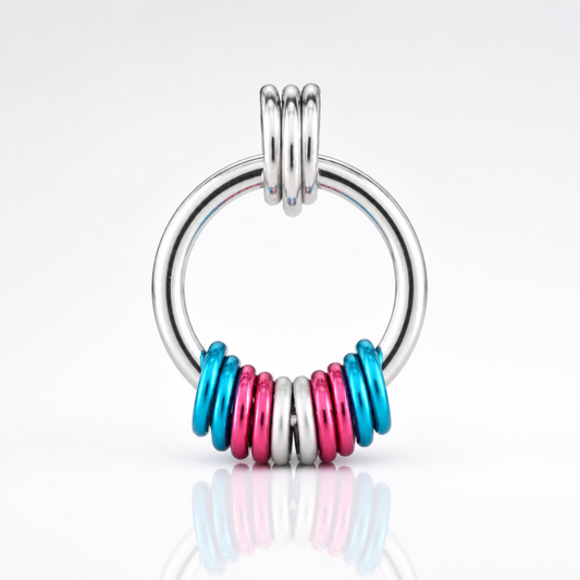 Handcrafted Transgender Pride coil fidget necklace featuring free-spinning pink, white, and blue aluminum rings on an adjustable stainless steel chain on a white background