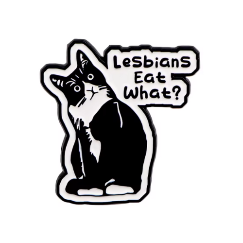 Funny tuxedo cat enamel pin with the phrase “Lesbians Eat What?”