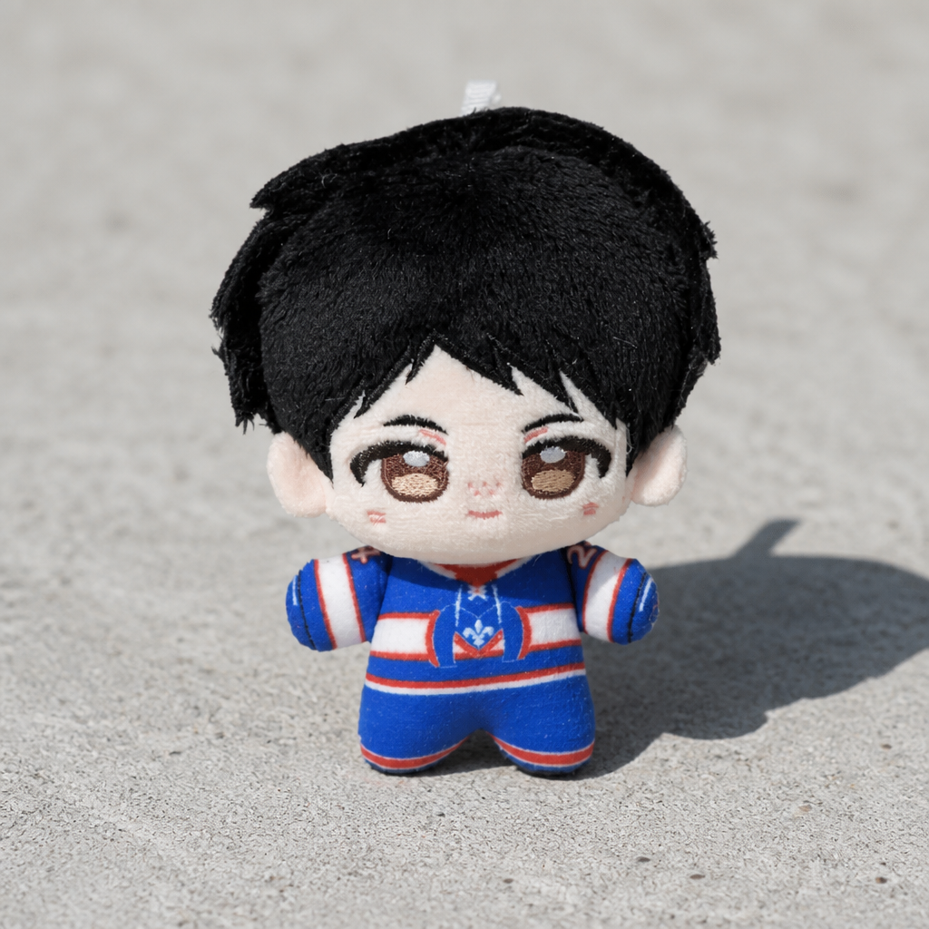 Heated Rivalry Hollander chibi-style plush keychain wearing blue hockey uniform on a concrete surface