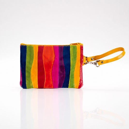 Small handcrafted rainbow leather wristlet featuring multiple zippered compartments and a removable wrist strap.