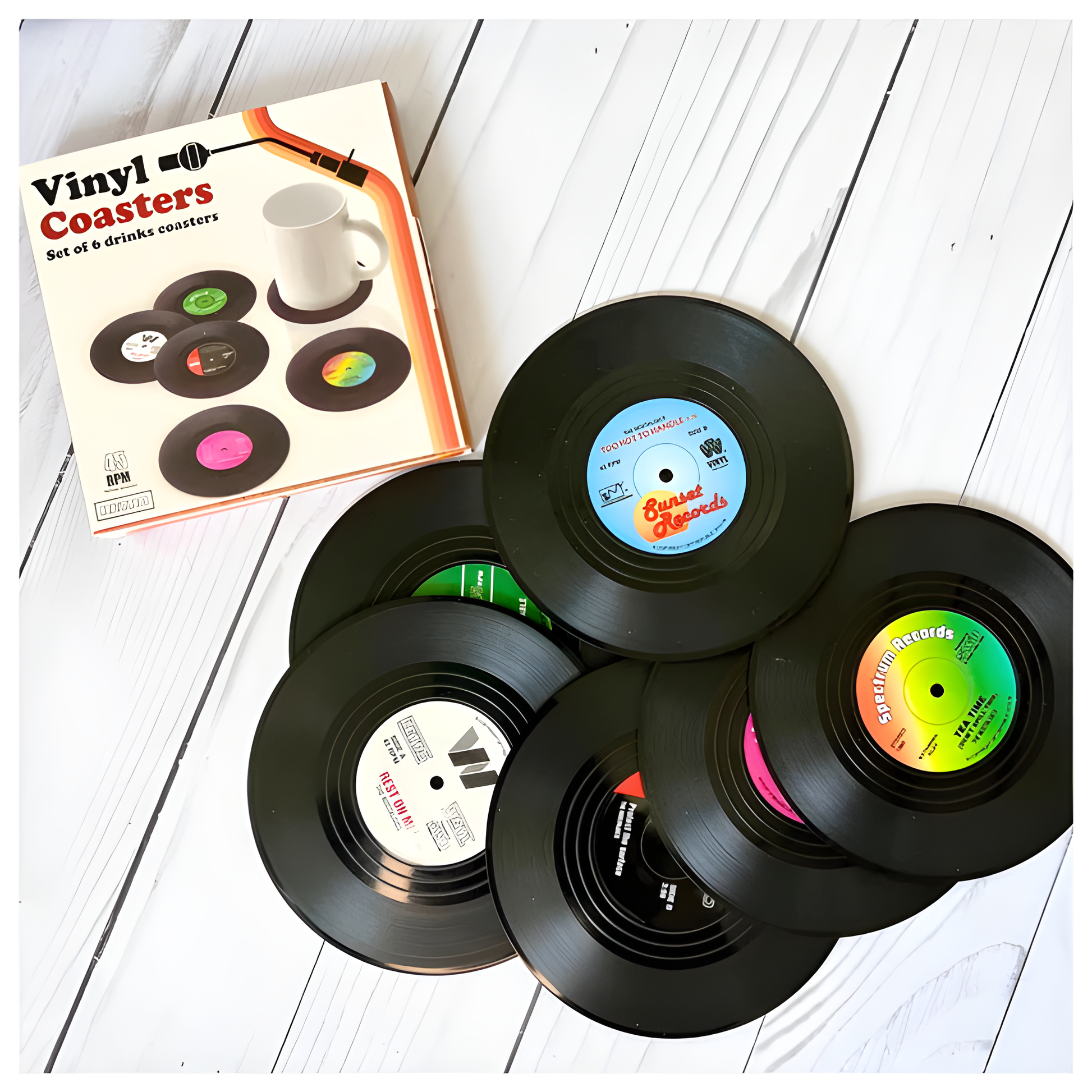 Set of six retro vinyl record drink coasters with colorful record label designs beside a coffee mug.