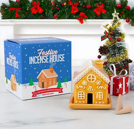 Ceramic gingerbread house incense burner with gingerbread incense cones creating smoke through the chimney.