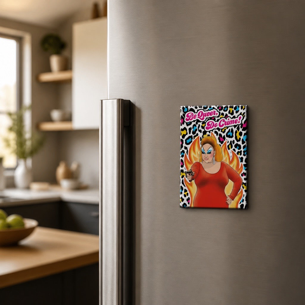 Be Queer Do Crime magnet featuring a drag queen surrounded by flames and colorful leopard print displayed on a refrigerator