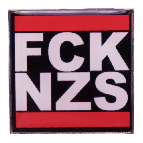 Black red and white enamel pin reading “FCK NZS”