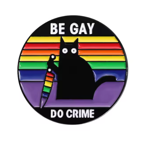 Be Gay Do Crime enamel pin featuring black cat holding rainbow knife with rainbow LGBTQ colors