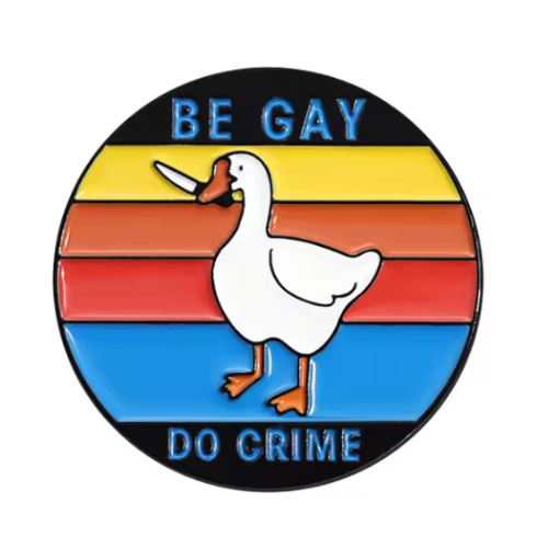 Be Gay Do Crime enamel pin featuring duck carrying knife with rainbow queer styling