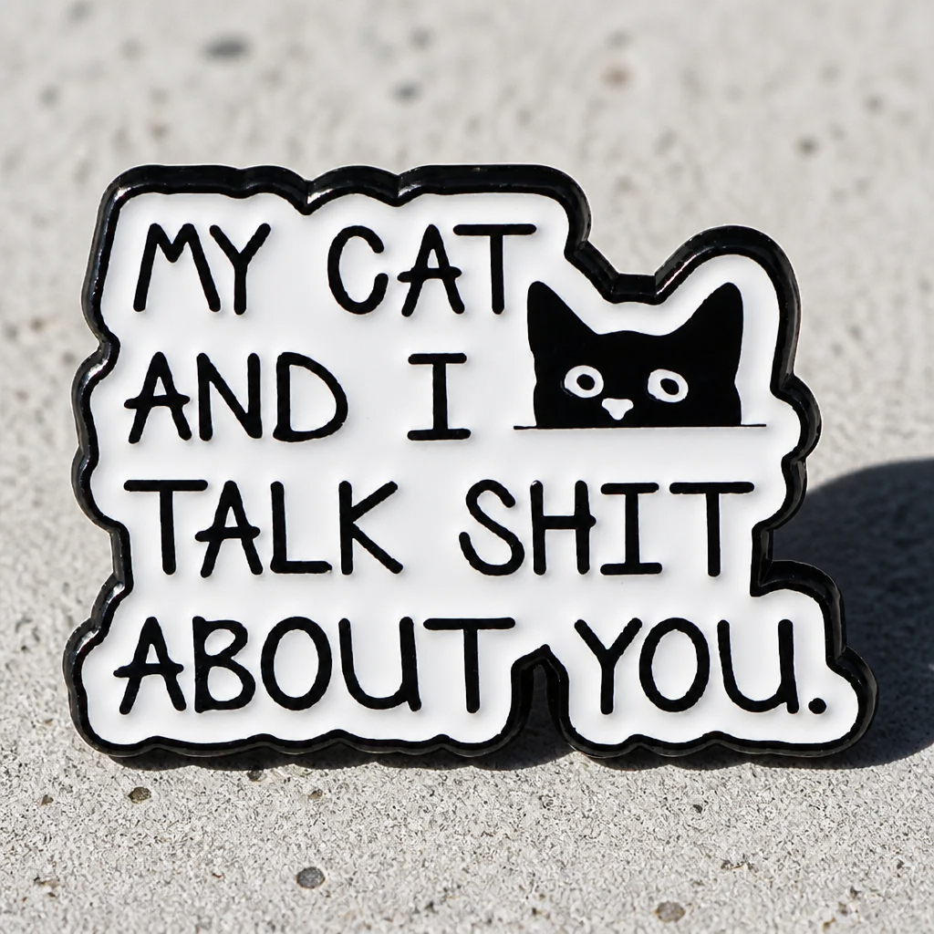 Funny enamel pin featuring black cat and text that says My Cat and I Talk Shit About You on a concrete surface