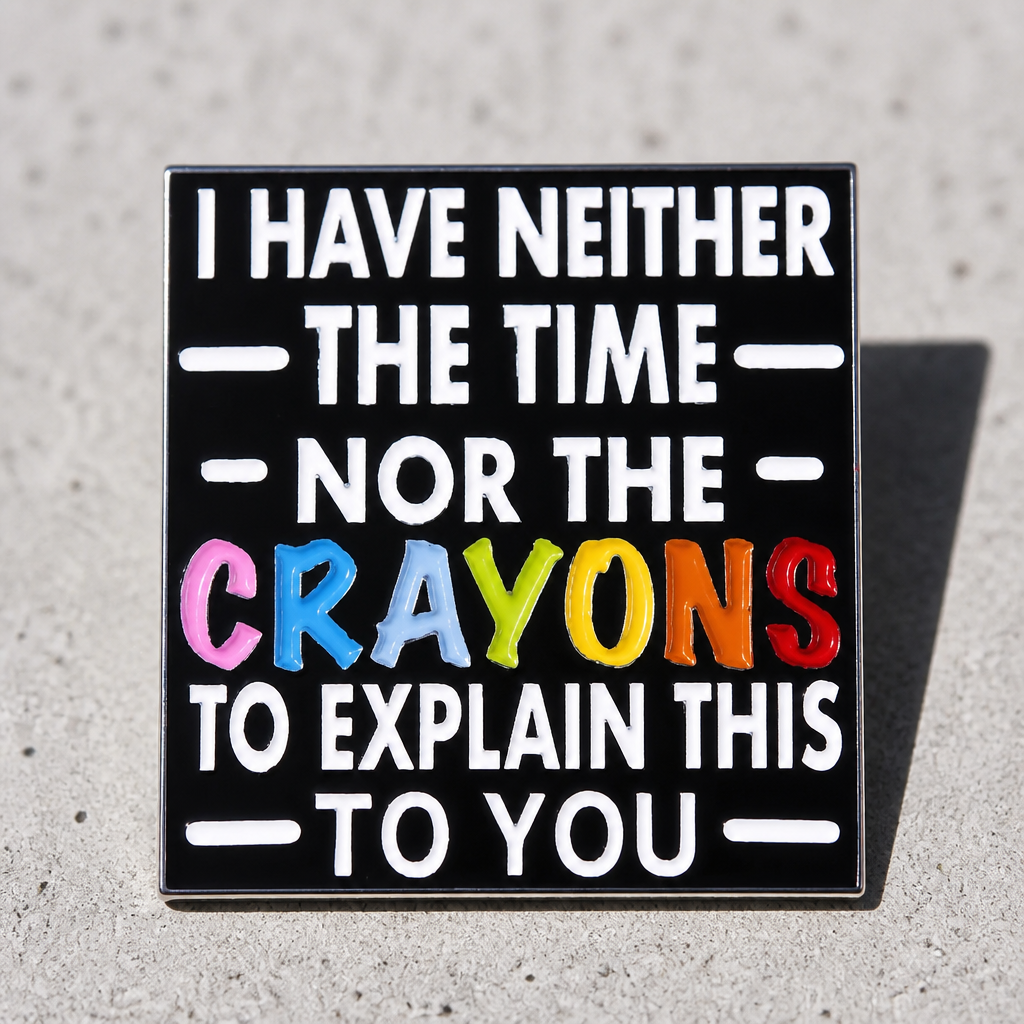 Funny sarcastic enamel pin reading I Have Neither the Time nor the Crayons with colorful lettering on a concrete surface