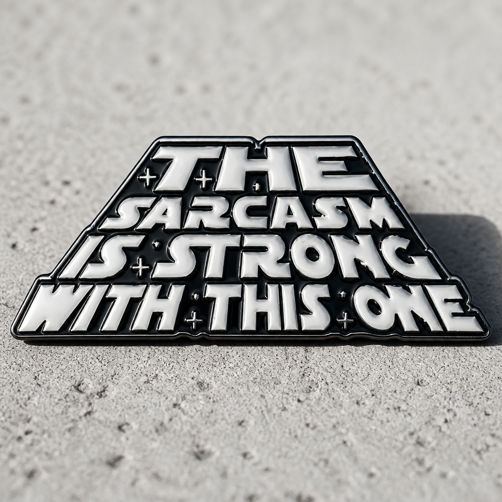 Funny sarcasm enamel pin with sci-fi inspired parody lettering design on a concrete surface