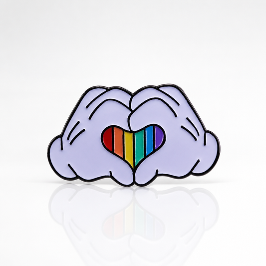 Cartoon-inspired gloved hands enamel pin forming a rainbow Pride heart
