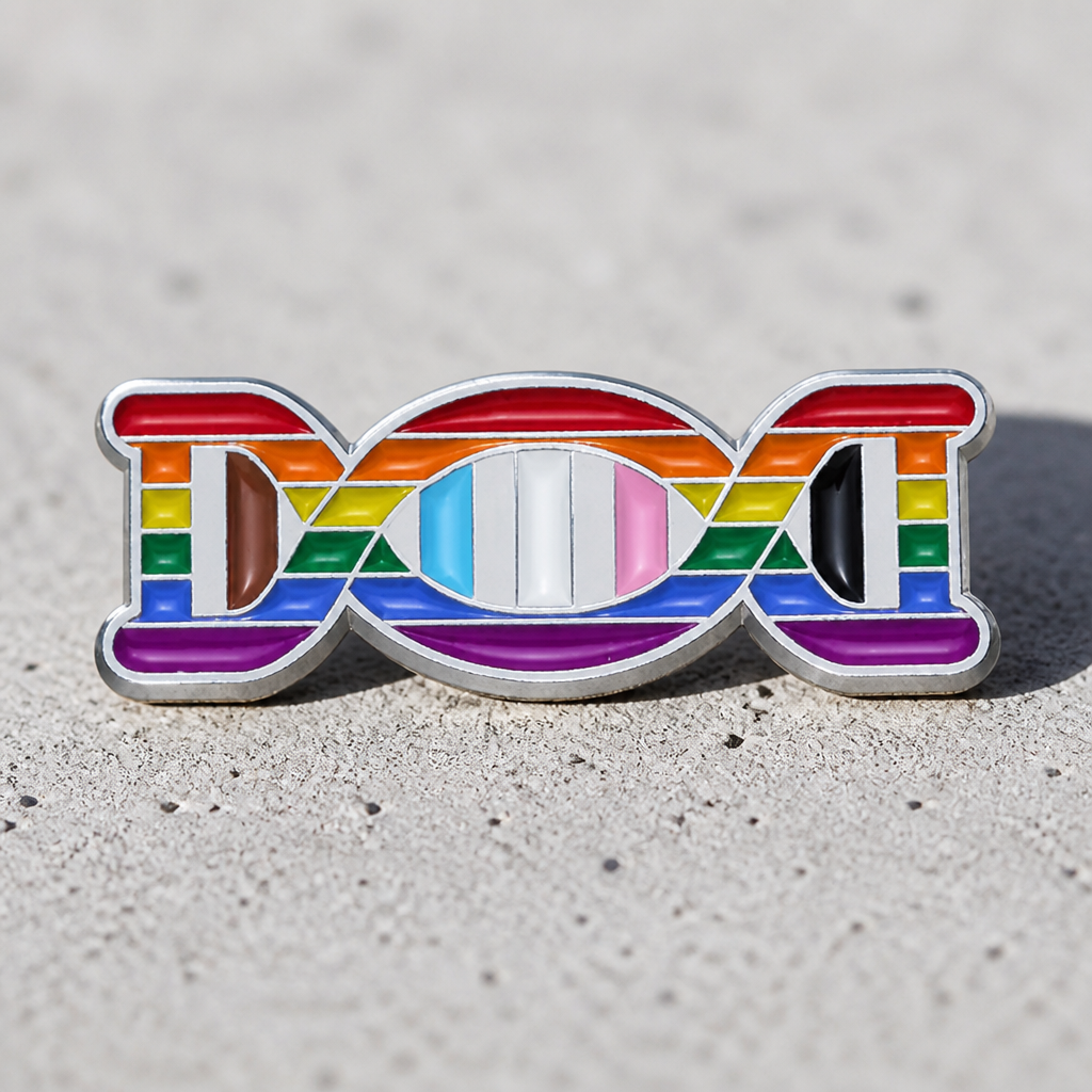 Progress Pride DNA enamel pin featuring rainbow, trans, and Philadelphia Pride flag colors in DNA design on a concrete surface