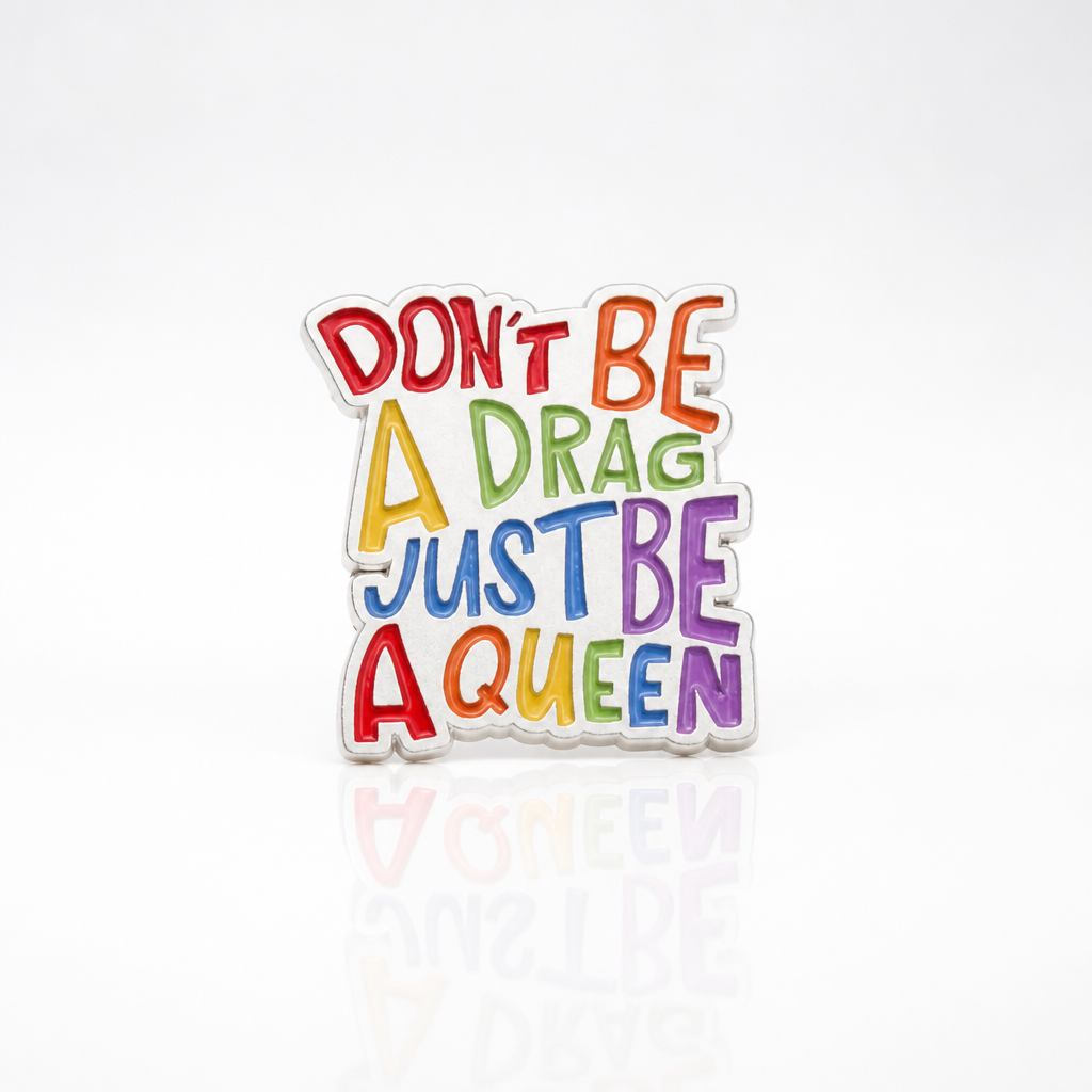 Colorful Don’t Be A Drag Just Be A Queen enamel pin with rainbow lettering