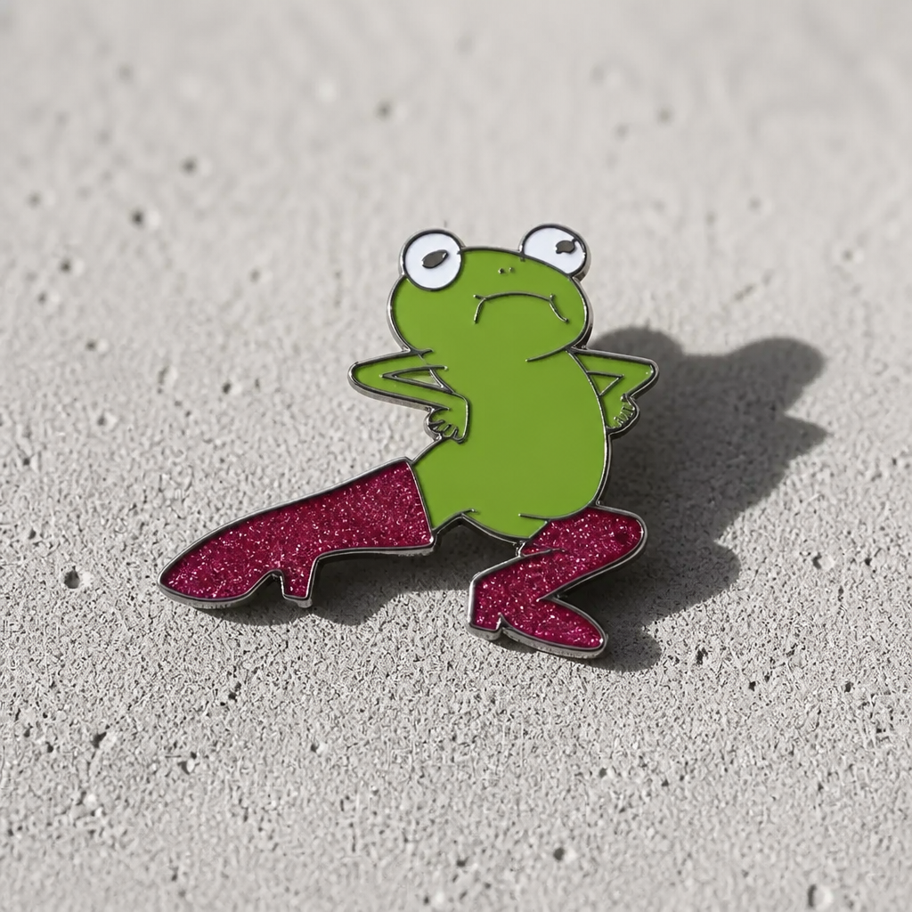 Cute frog enamel pin wearing glittery pink thigh-high boots on a concrete surface