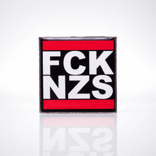Black red and white enamel pin reading “FCK NZS”