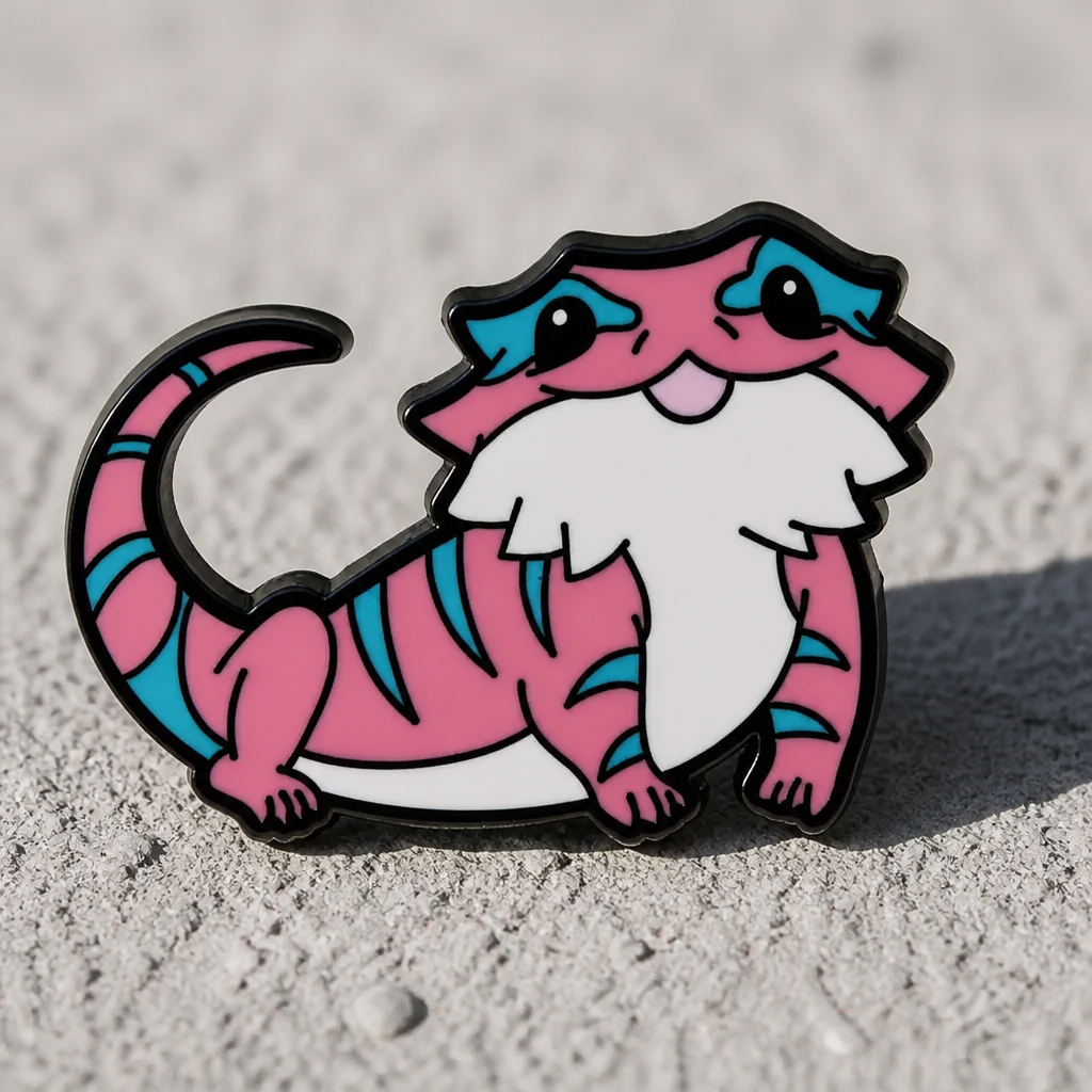 Cute bearded dragon enamel pin featuring Trans Pride flag colors on a concrete surface