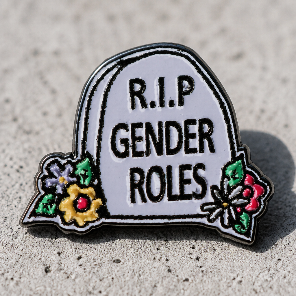 R.I.P. Gender Roles enamel pin featuring tombstone design with colorful flowers on a concrete surface