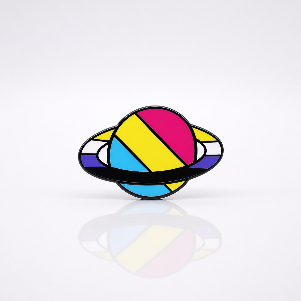 Saturn-inspired enamel pin featuring Pansexual and Nonbinary Pride flag colors on a ringed planet design