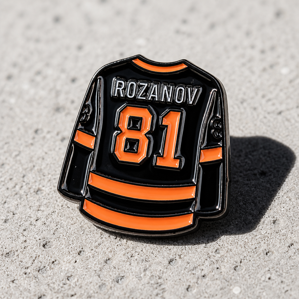 Heated Rivalry Rozanov home jersey enamel pin with black and gold hockey uniform design on a concrete surface