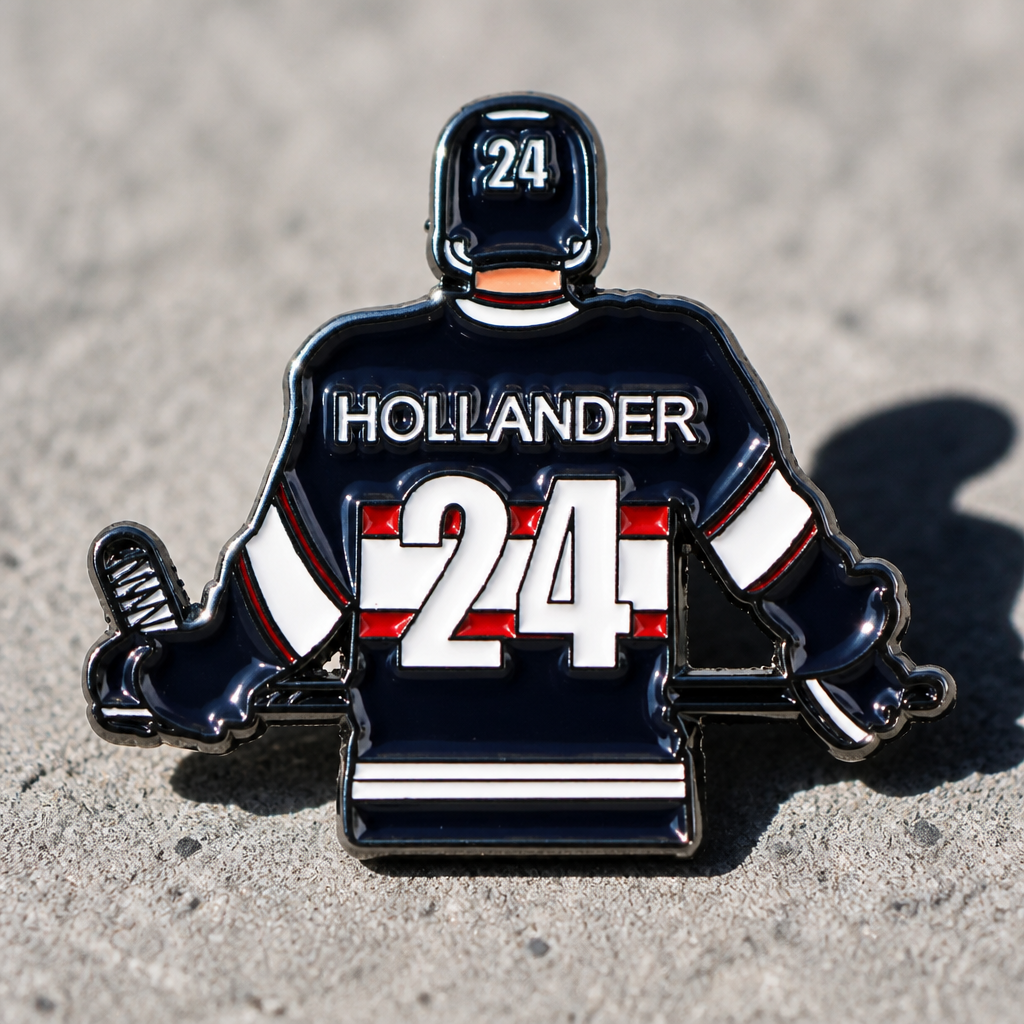 Heated Rivalry Hollander away jersey enamel pin with hockey uniform design and number 24 on a concrete surface