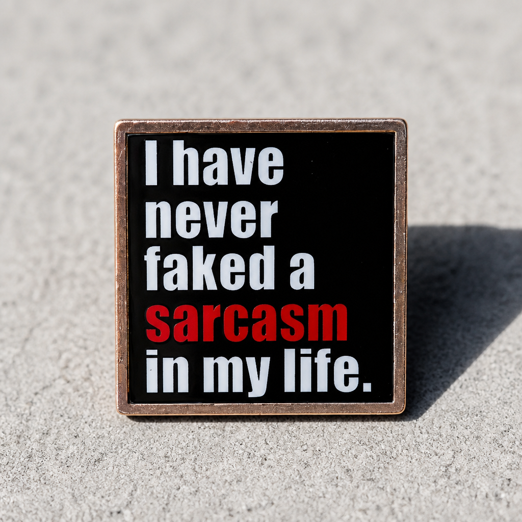 Black enamel pin featuring the phrase "I Have Never Faked a Sarcasm in My Life" with the word "sarcasm" highlighted in red on a concrete background