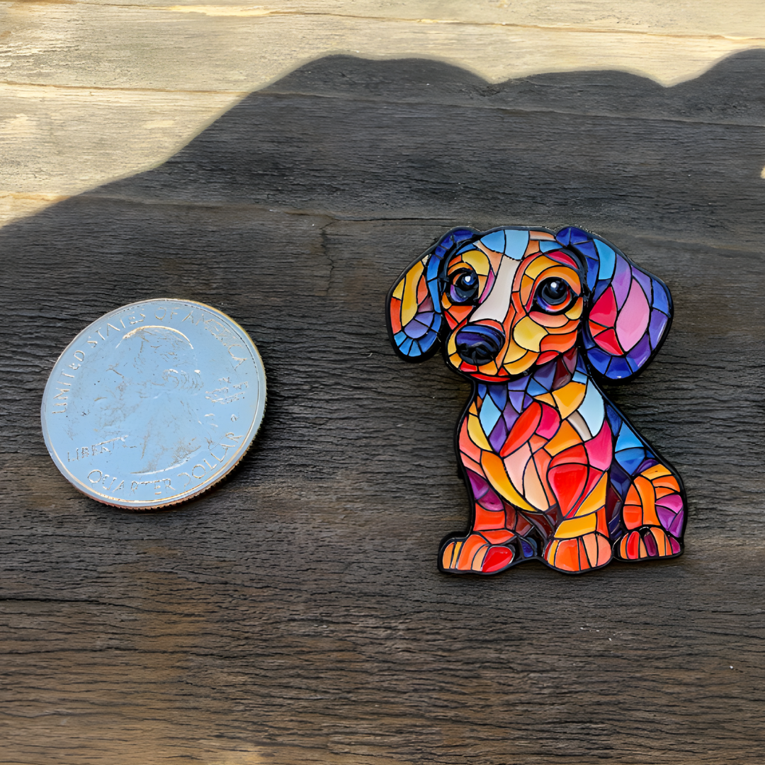 Colorful stained glass puppy enamel pin with vibrant geometric mosaic artwork next to a quarter for size reference