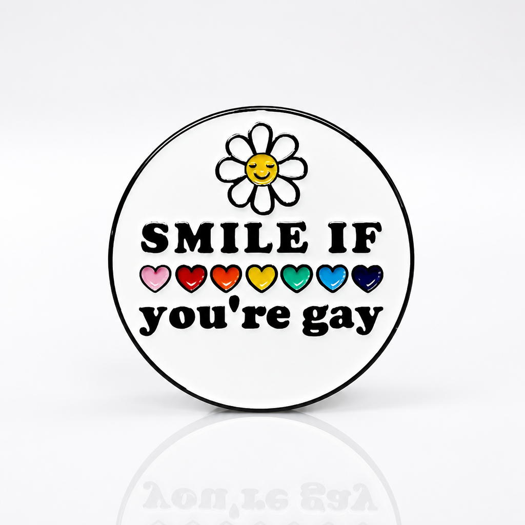 Round hard enamel pin featuring a smiling daisy, rainbow hearts, and the phrase "Smile If You're Gay."