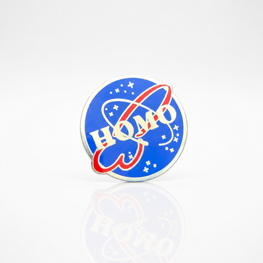 HOMO Space Program enamel pin featuring a retro space-agency-inspired logo design in blue and red