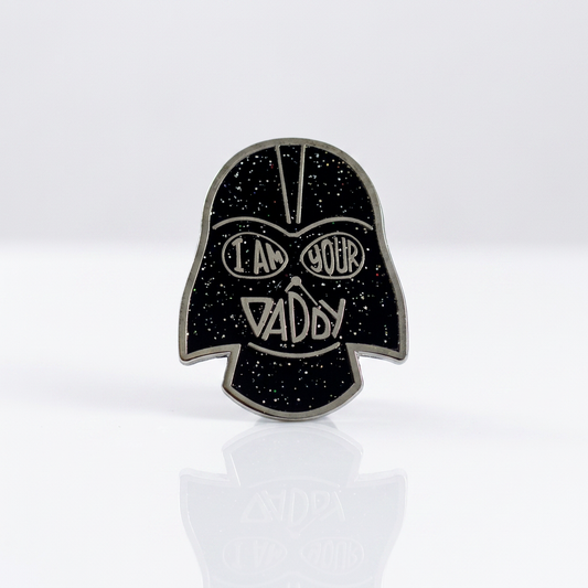 Black glitter enamel pin reading I Am Your Daddy with bold graphic artwork and gold-tone details
