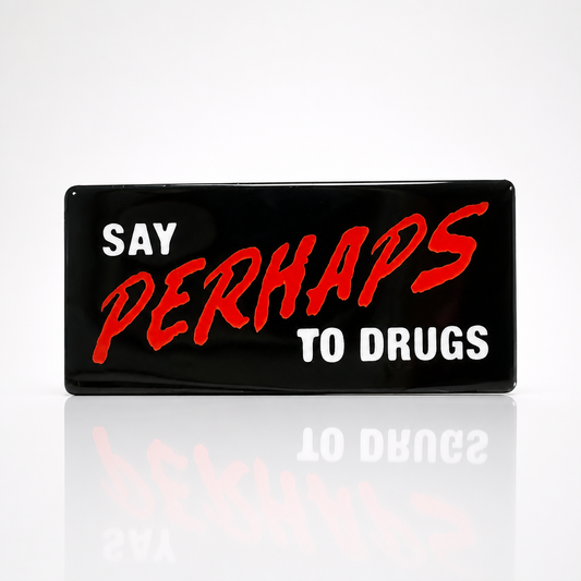 Say Perhaps to Drugs enamel pin featuring bold red and white lettering on a black background