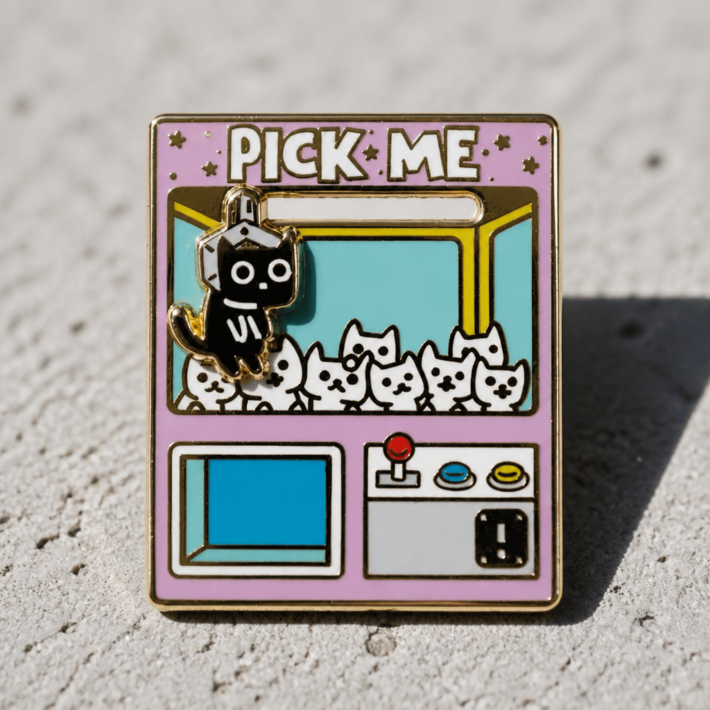 Interactive Pick Me Claw Machine deluxe enamel pin featuring a movable black cat inside a colorful arcade claw machine on a cement surface