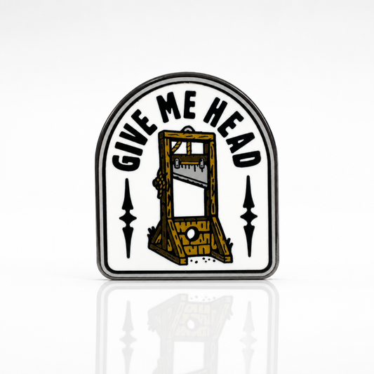 Give Me Head enamel pin featuring a vintage guillotine illustration and humorous text