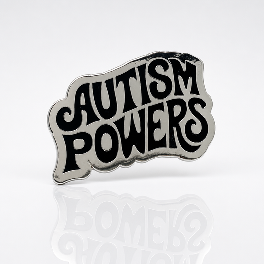 Silver-plated hard enamel pin featuring the words Autism Powers in bold black retro lettering