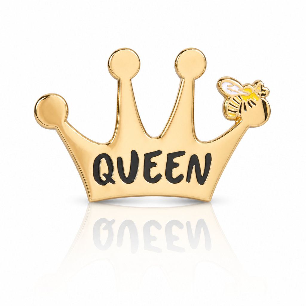 Gold Queen Bee hard enamel pin by Rebellious Pins featuring a crown with a small bee detail and bold Queen lettering.