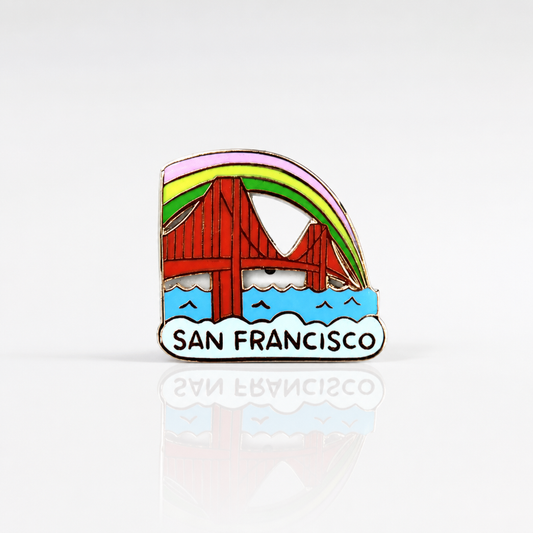 Hard enamel San Francisco Golden Gate Bridge pin featuring a colorful rainbow arch above the bridge with gold metal detailing and a double-post backing on a white background