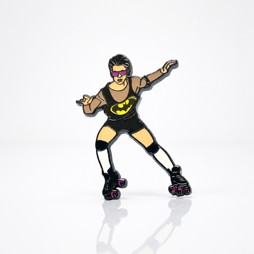 Hard enamel pin featuring a retro roller skater wearing sunglasses and a black outfit with roller skates in a playful disco-inspired design