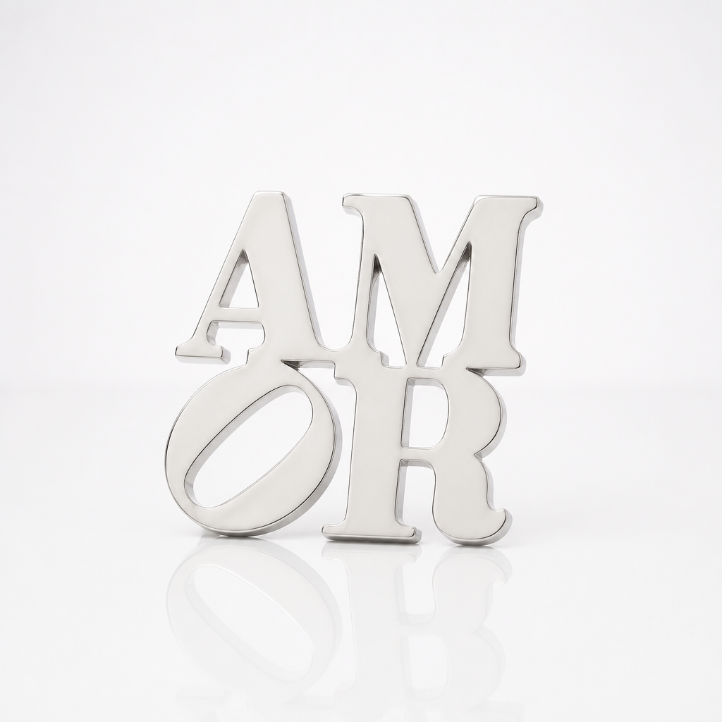 Officially licensed Robert Indiana AMOR enamel pin featuring the iconic stacked lettering in a polished silver finish.