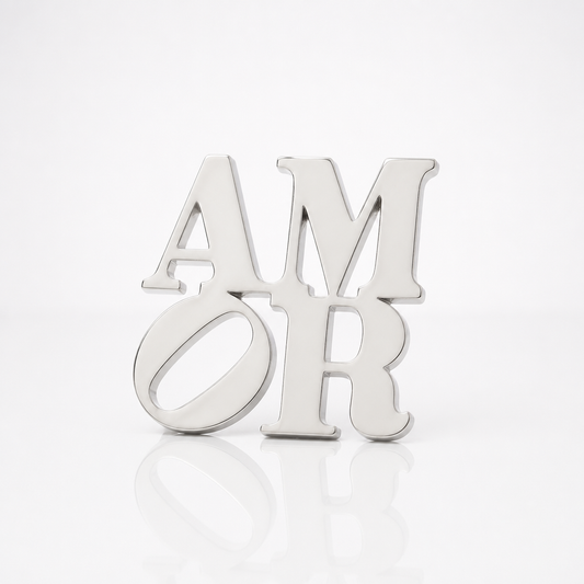 Officially licensed Robert Indiana AMOR enamel pin featuring the iconic stacked lettering in a polished silver finish.