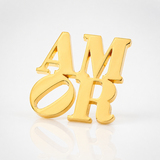Officially licensed Robert Indiana AMOR enamel pin featuring the iconic stacked lettering in a polished gold finish.