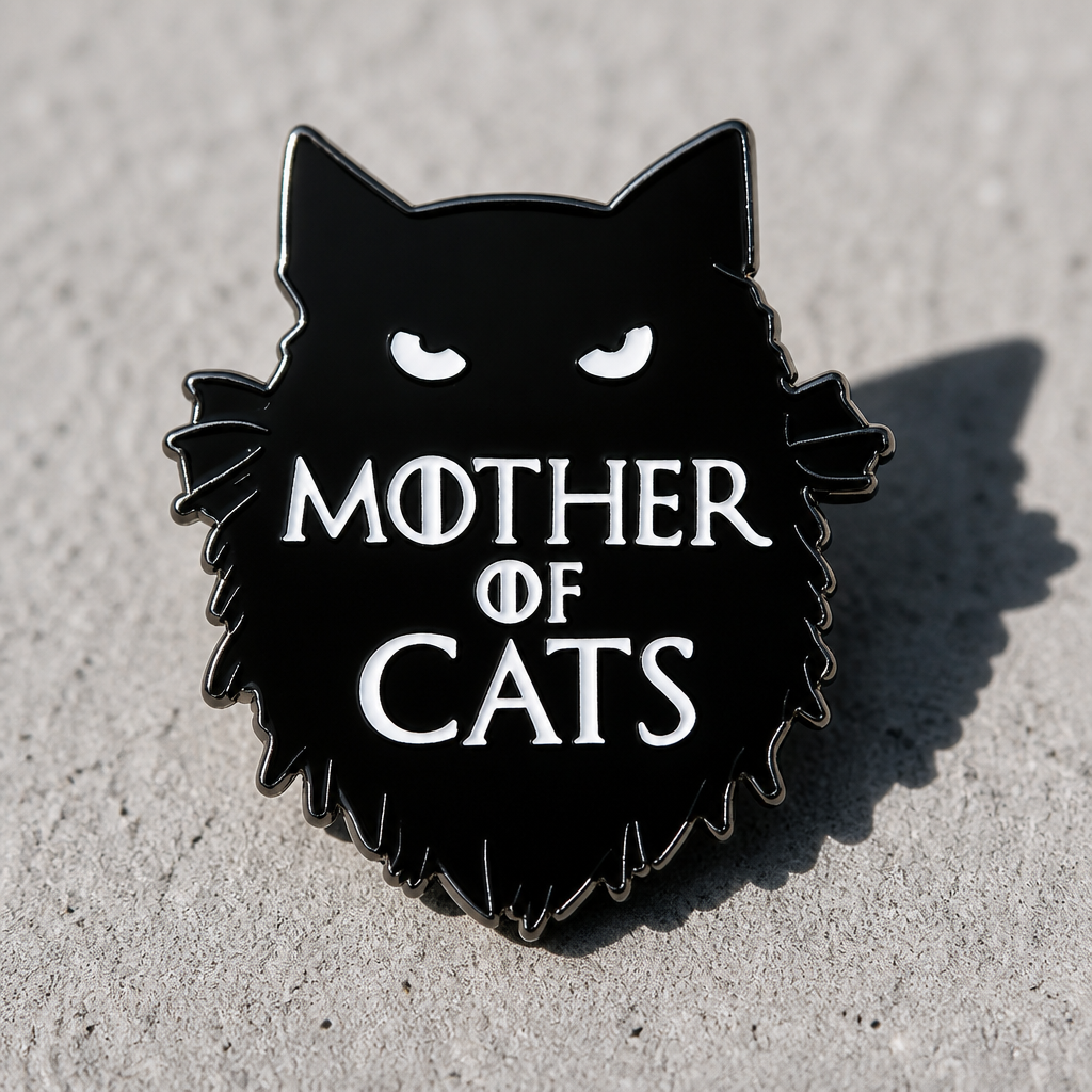 Black gothic enamel pin featuring cat silhouette and the phrase “Mother of Cats” on a concrete surface