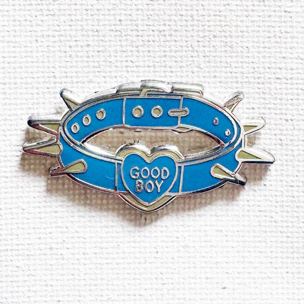 Good Boy Collar enamel pin featuring a blue spiked collar with a heart-shaped charm