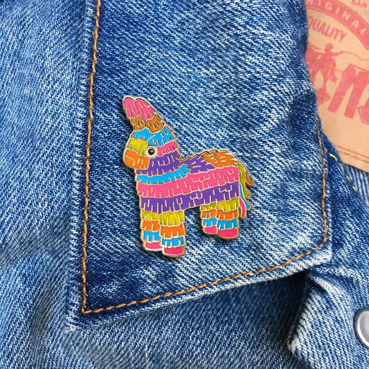 Rainbow piñata enamel pin with colorful layered fringe design