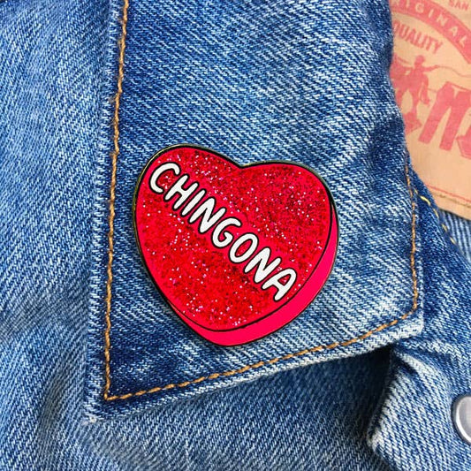 Pink glitter heart enamel pin with Chingona text design