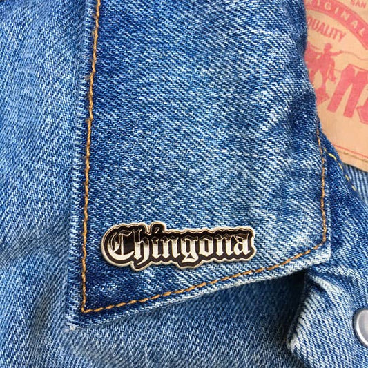 Black and silver Chingona script enamel pin with gothic-style lettering