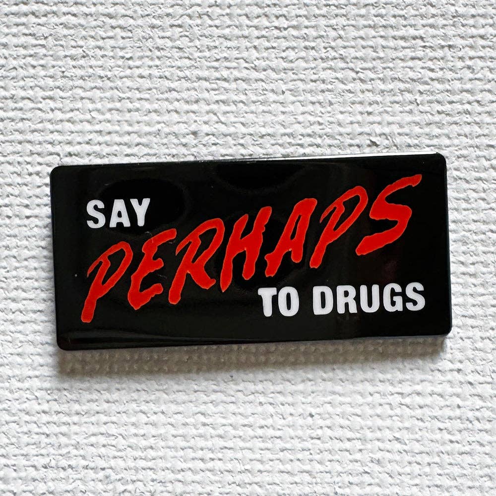 Say Perhaps to Drugs enamel pin featuring bold red and white lettering on a black background