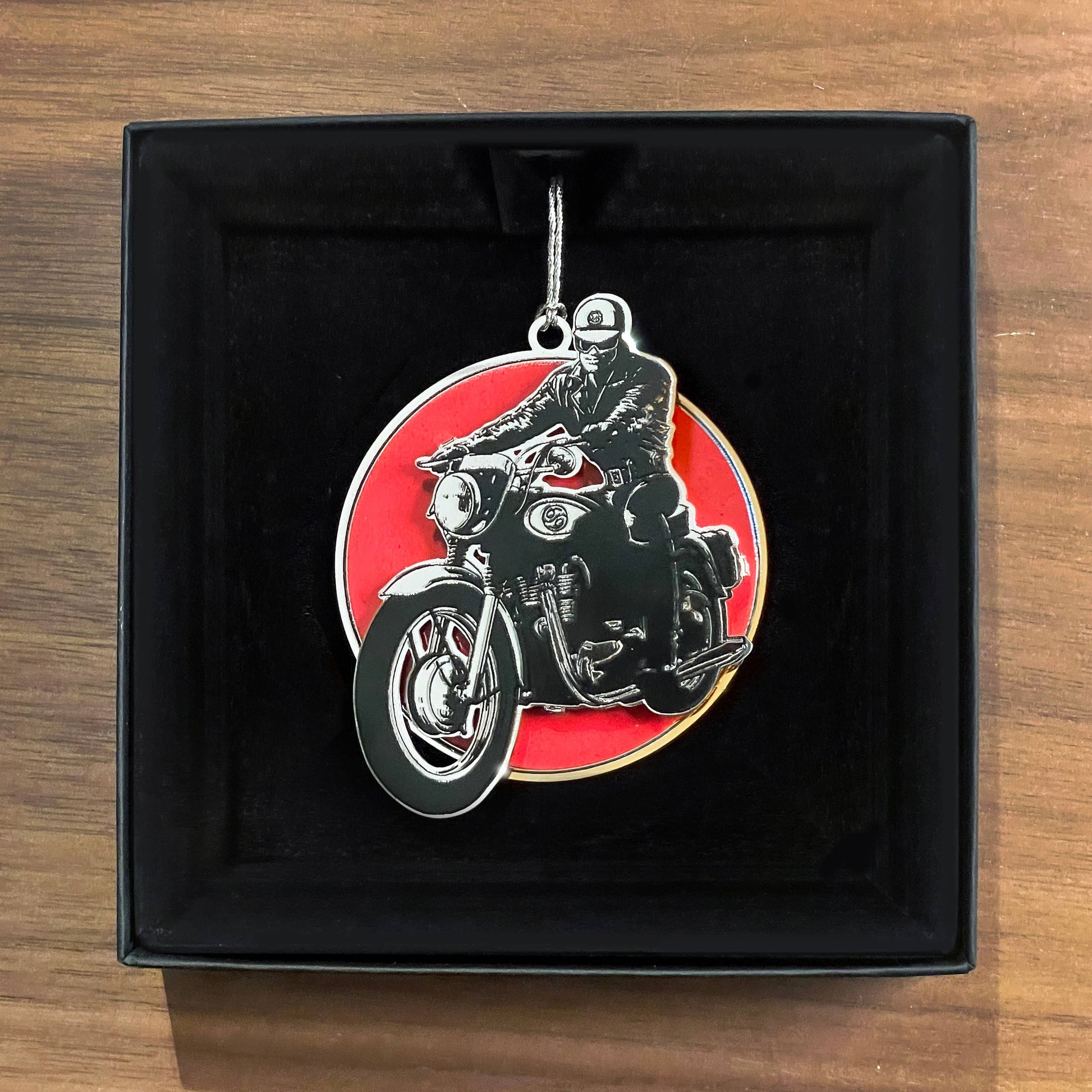 Tom of Finland limited edition biker metal ornament featuring a classic leather-clad motorcyclist on a red background in a black embossed gift box.