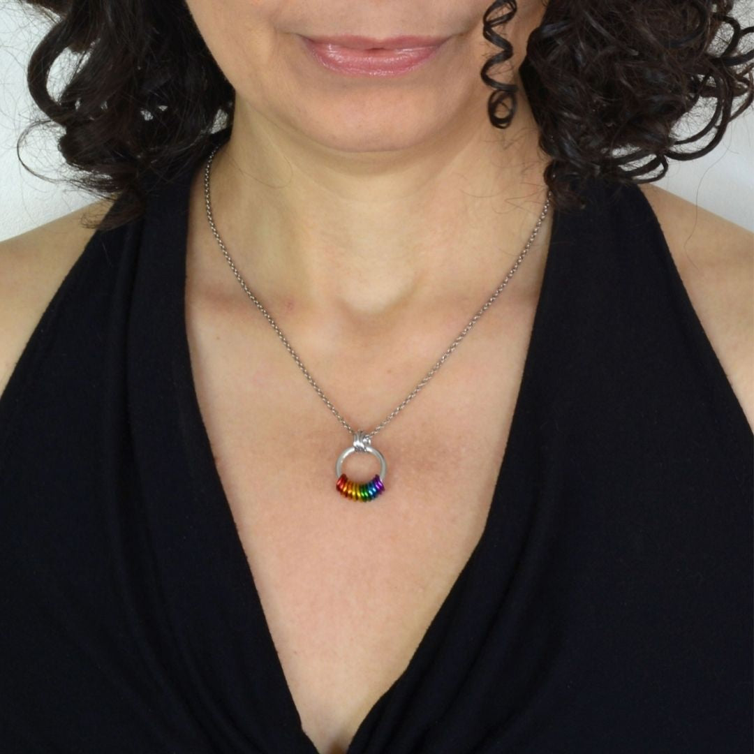 Model wearing a Pride Coil Fidget Necklace to show necklace length and pendant size